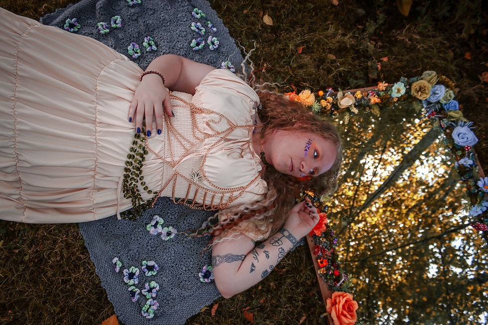 Eye-level view of a decorated mirror frame surrounded by vibrant flowers and moss