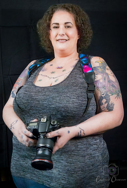 Smiling photographer holding camera