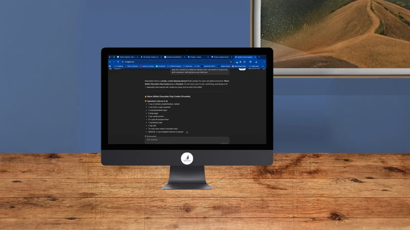 ChatGPT prompting on computer screen sitting on a desk with a blue wall with a space themed picture