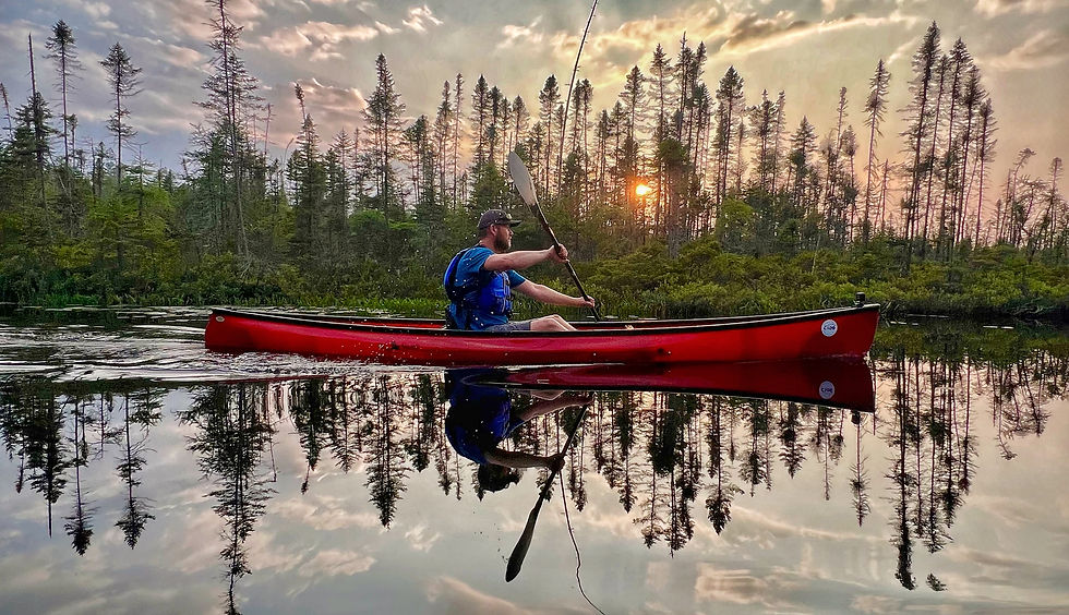A Swift Pack Canoe paddling on the Osgood River,NY at sunset