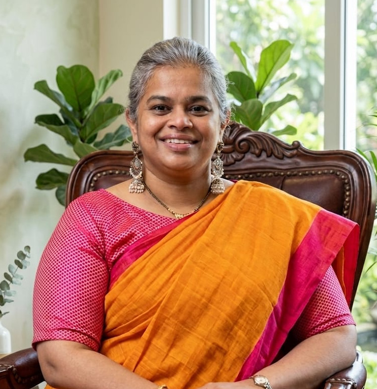 Portrait of a therapist sitting on a chair in a calm, plant-filled therapy room, landscape