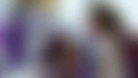 woman tying bow onto wedding chair