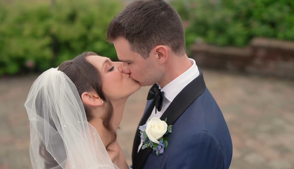 bride and groom kiss in garden