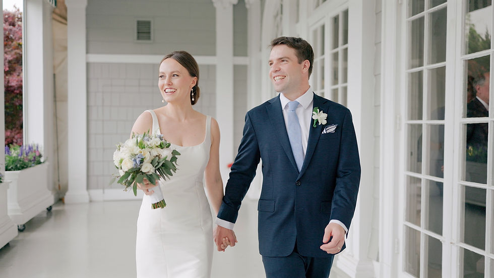 bride and groom holding hands while walking along the patio of their venue