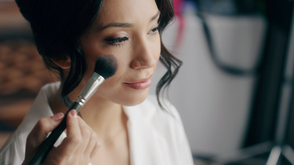 bride having makeup applied on wedding day