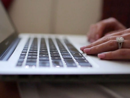 using a laptop to create a wedding website