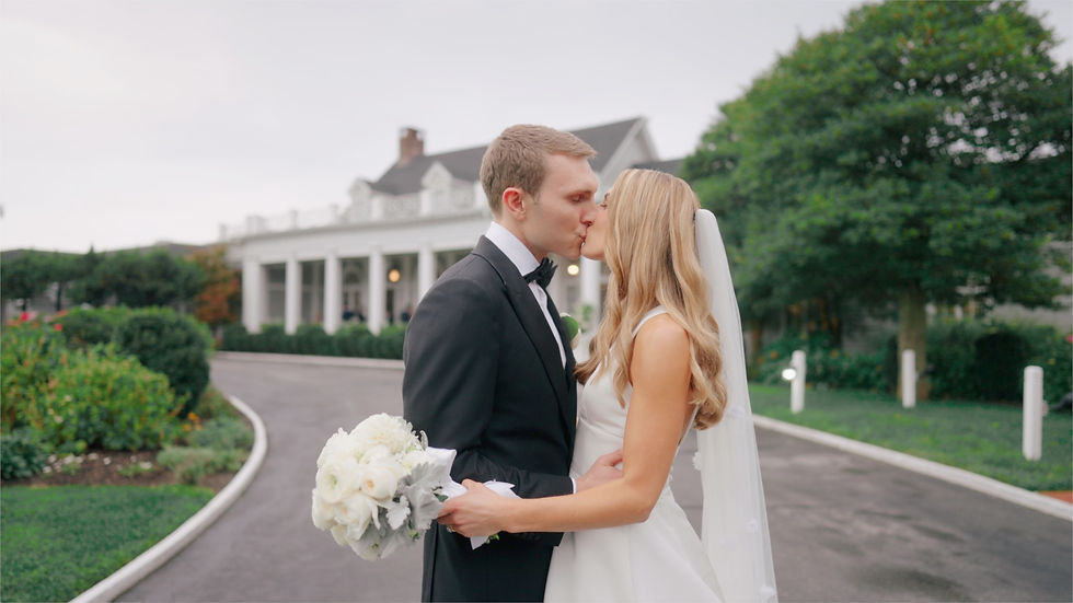 bride and groom kiss outside on wedding day