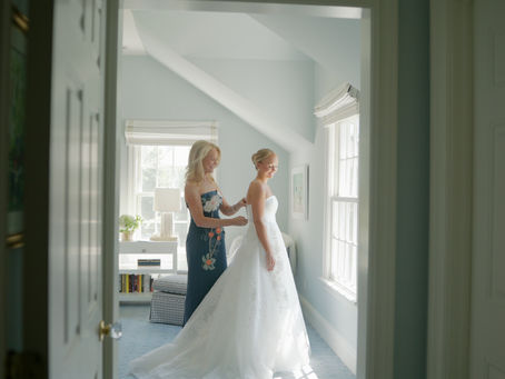 bride in her ball gown stands with her mother