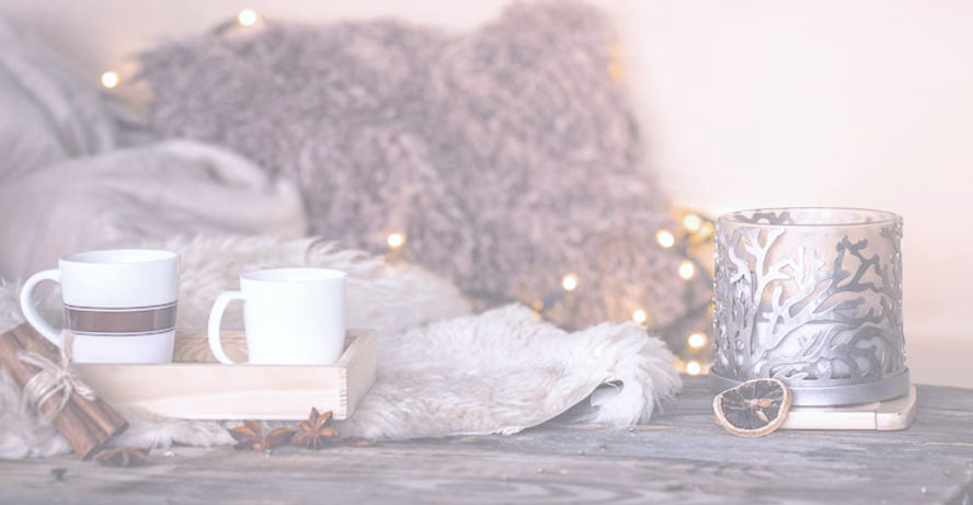 still-life-home-atmosphere-interior-with-cups-candles-table-cozy-bedspreads_169016-1307_ed