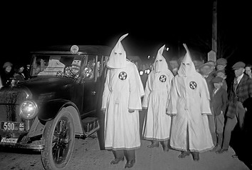 Three Ku Klux Klan members at a Ku Klux Klan parade through counties in Northern Virginia