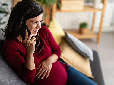 A pregnant woman on the phone.