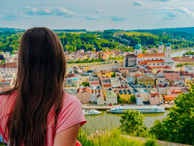 woman looks out over a  colorful European town