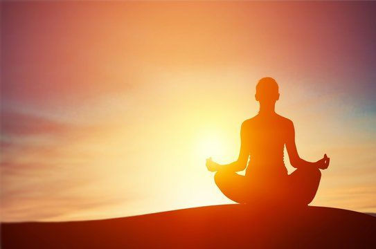 A person meditates on the vast open air