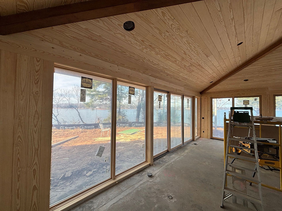 Eye-level view of a renovated custom home under construction on a lakefront lot