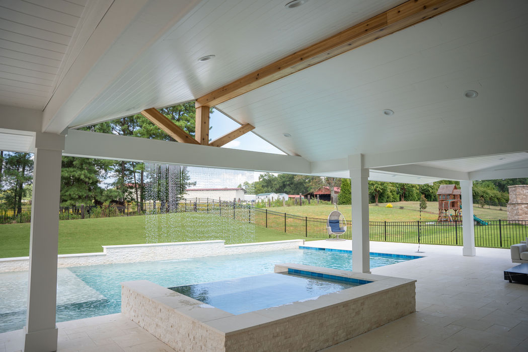 outdoor living renovation with waterfall and pool Denver NC by REVIVAL Construction NC