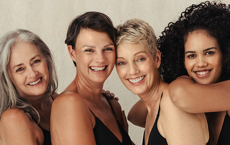 Four diverse women of all ages embracing their bodies. Group of smiling women wearing blac