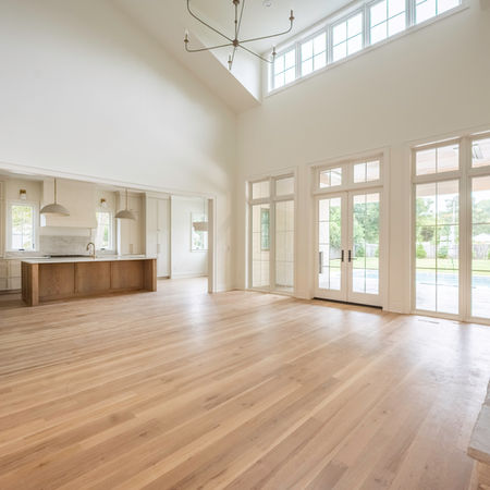 Open-concept living room with custom fireplace design in a Sedgefield custom home by KEEN Building Co Charlotte NC.
