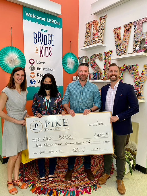 Pike Properties Foundation Gives back Check Presentation Bridge for Kids