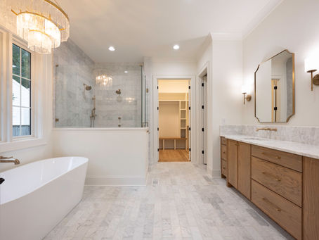 Marble primary bathroom with body sprayers, rain shower, and luxury finishes built by KEEN Building Co Charlotte NC.