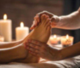 Foot massage with lit candles