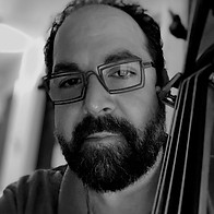 Black and white headshot of Michael DiTrolio standing with string bass
