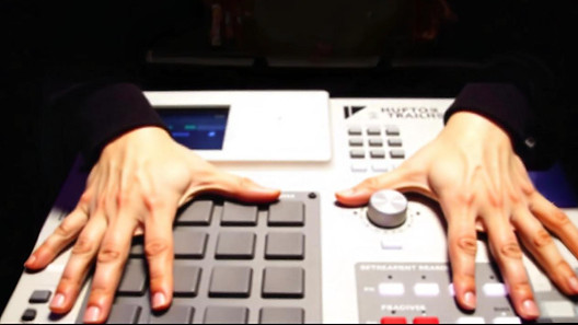 freepik__tan-hands-pressing-the-buttons-of-a-white-mpc-musi__24624.jpeg