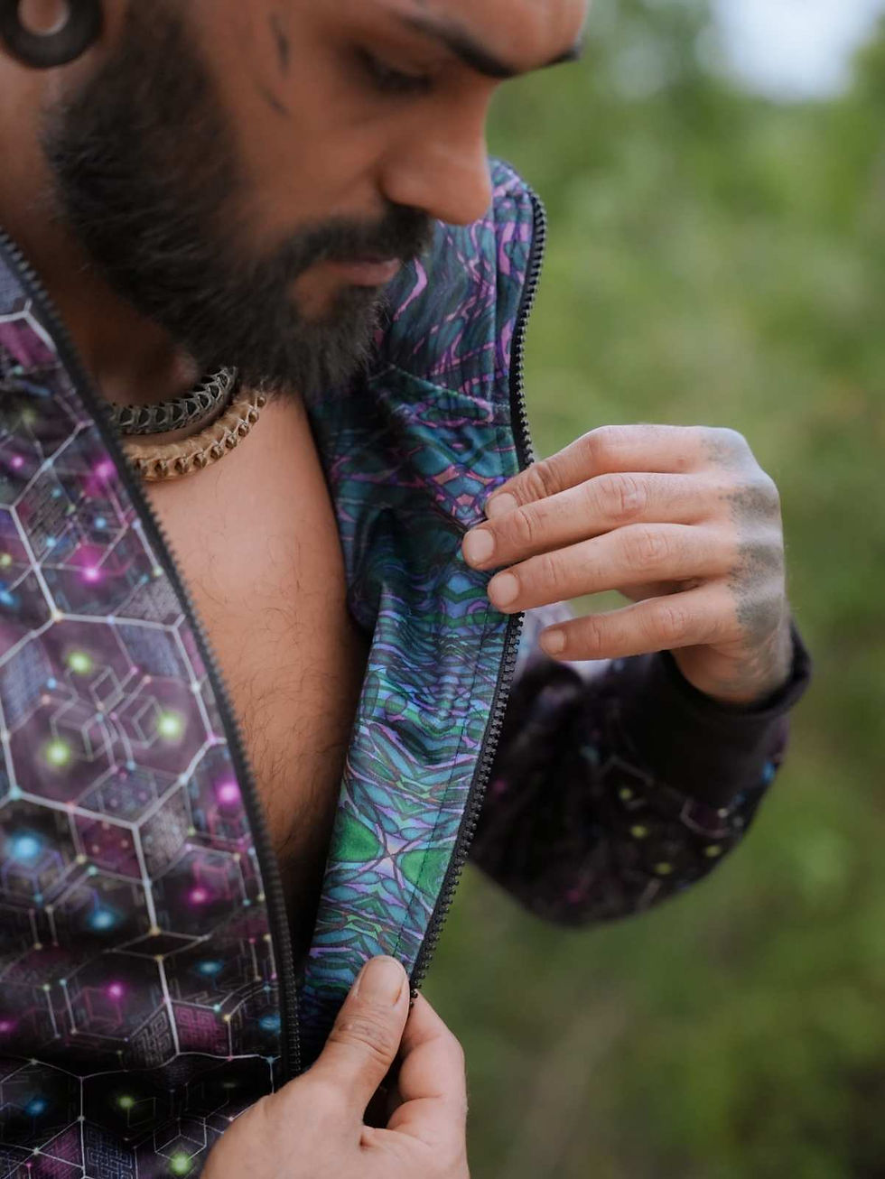 Thumbnail: Close up view of men unzipping the Reversible Windbreaker showing the other side artwork