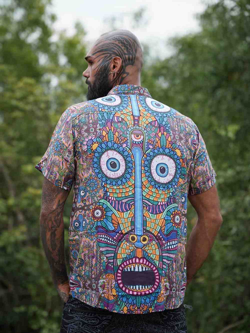 View from behind of vibrant psychedelic art shirt featuring tribal mask art work