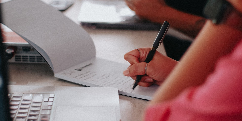 A woman scribbling on her notebook.