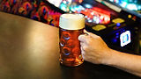 Hand holding a mug of amber beer