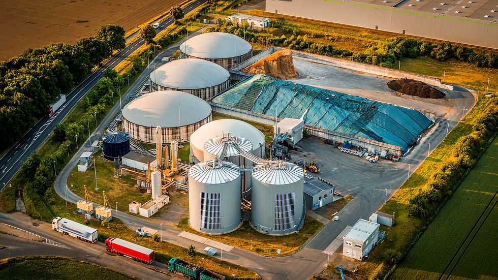 Aerial view of a biogas plant, large tanks, and industrial structures.
