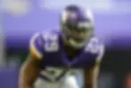 Roger Goodell and Xavier Rhodes holding a Rhodes 1 jersey.