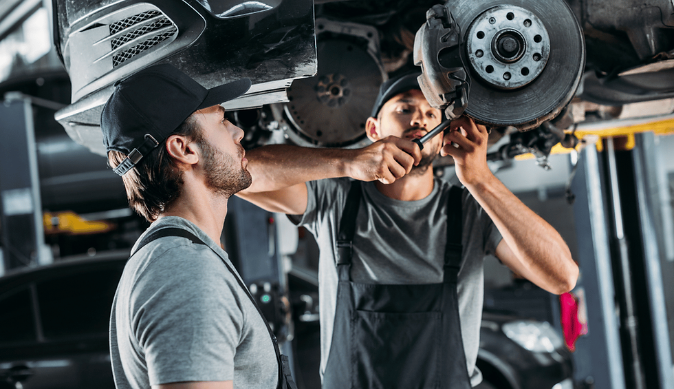 mechanics repairing car machine
