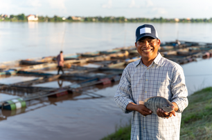 Farmer with Fish in Aqua Culture setting