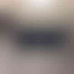 After renovation: InstaSkin skincare salon logo sign on a gray wall inside the renovated salon.