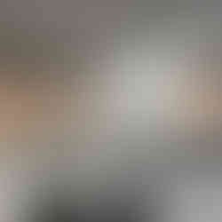 After renovation: Modern skincare treatment room with a comfortable treatment bed, medical equipment, and a large window displaying the InstaSkin logo in the renovated salon.