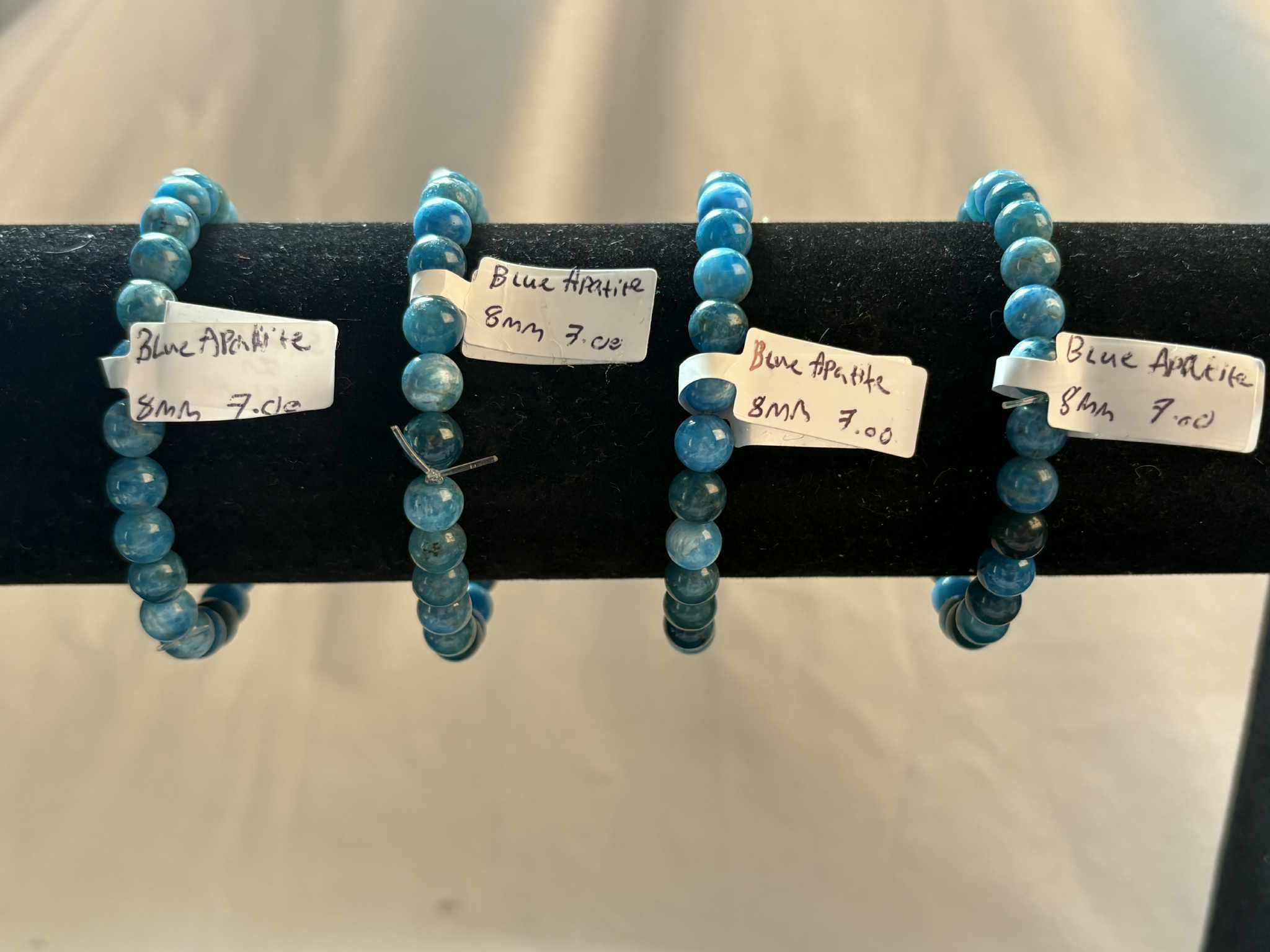 Blue Apatite Bracelets on display with price tags