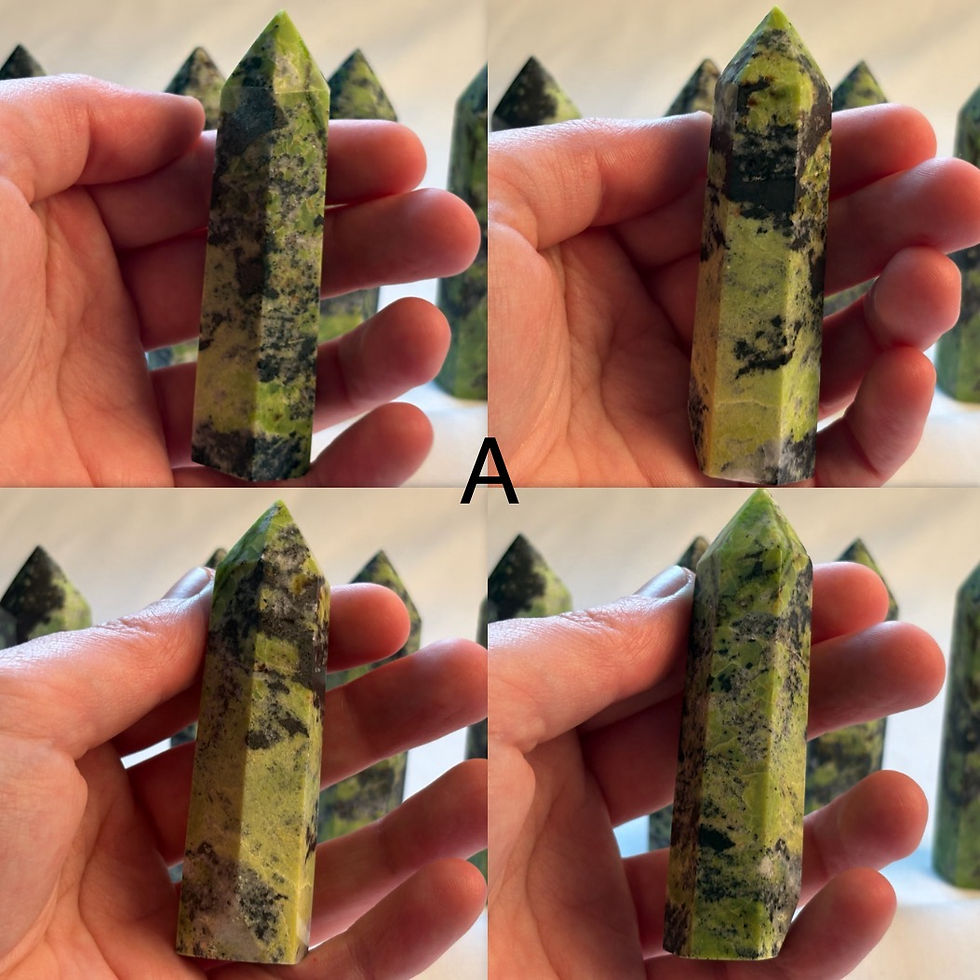 Thumbnail: Hand holding Chrysocolla mix Small Tower stone with a green and black color, letter A.