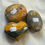 Thumbnail: Three decorative stones labeled A, B, and C with vibrant colors on display.
