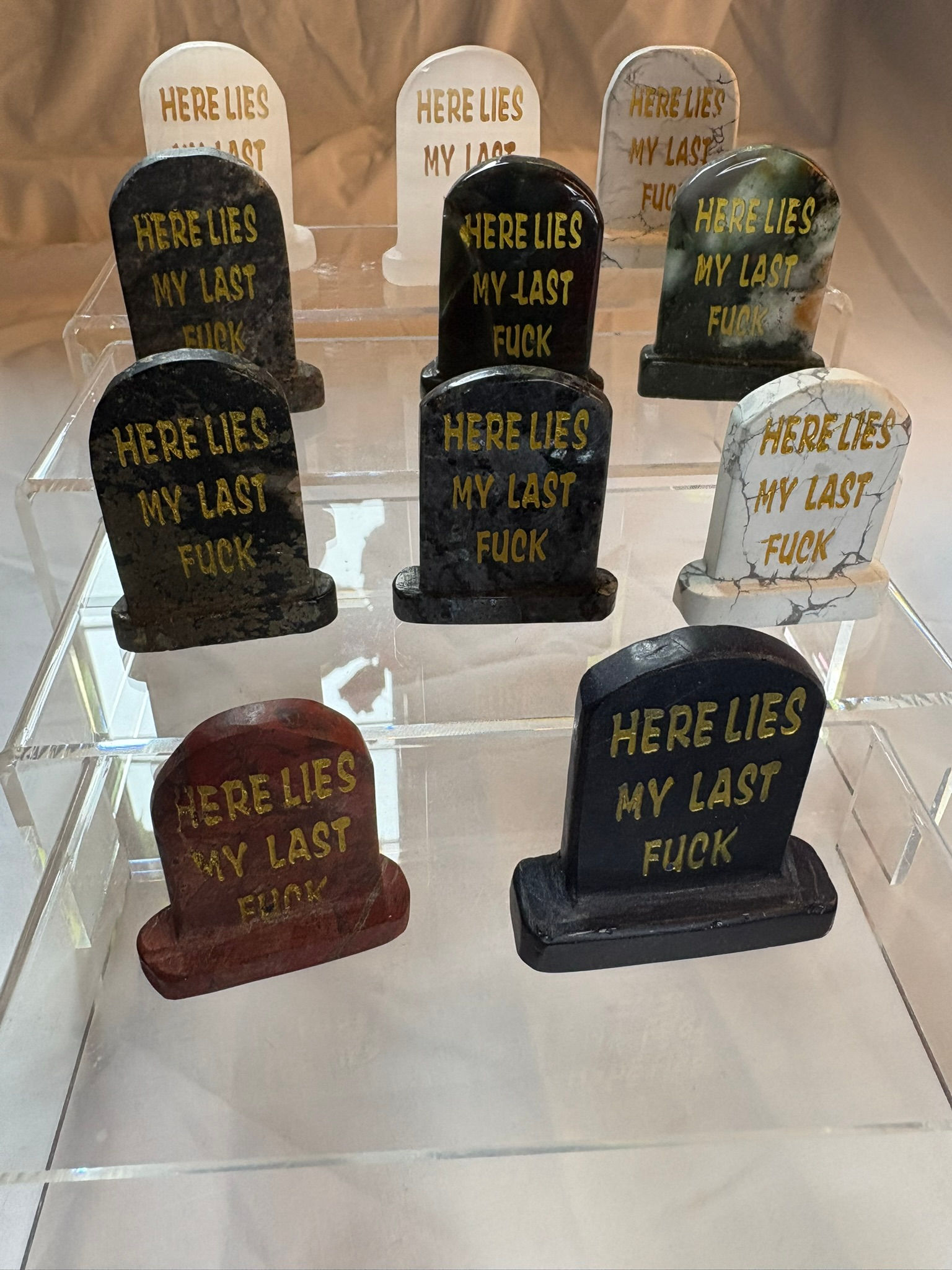 Tombstones display "HERE LIES MY LAST FUCK" on display for sale