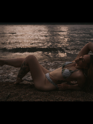 Lipedema body on the beach. Moody dark photo that shows the beauty of owning lipedema