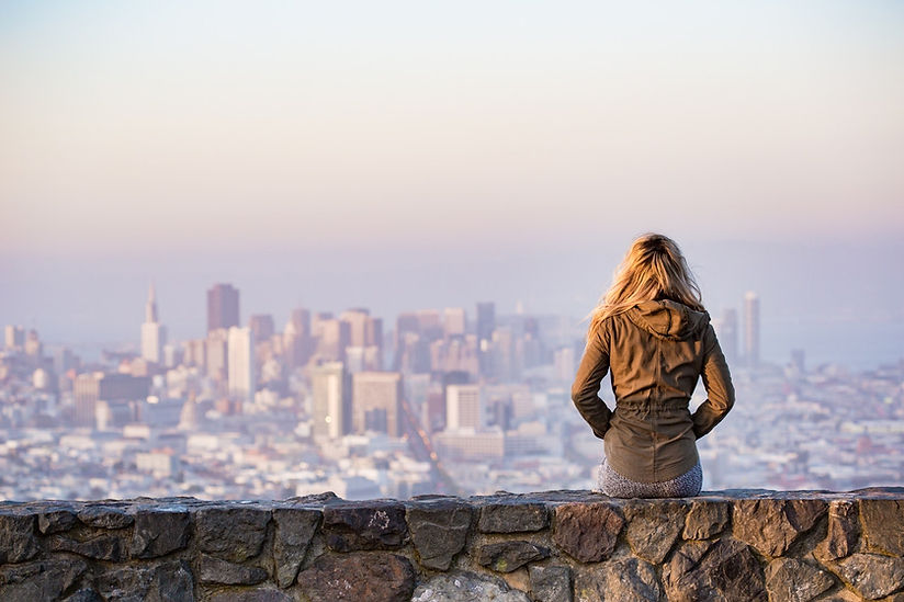 Young woman overlooking city scape representing career opportunities for students & recent graduates