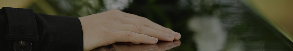 close-up-female-hand-coffin-saying-goodb