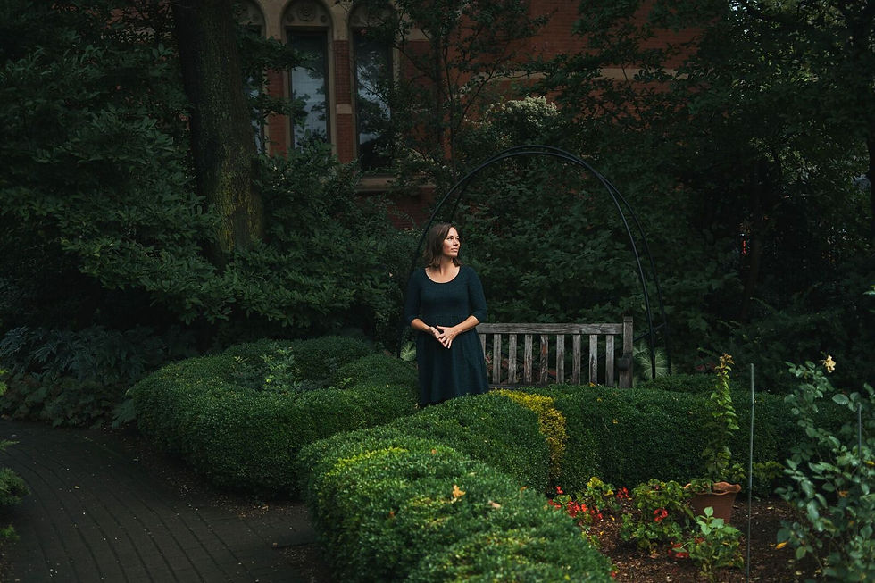 lady in black standing in Jefferson Market Garden