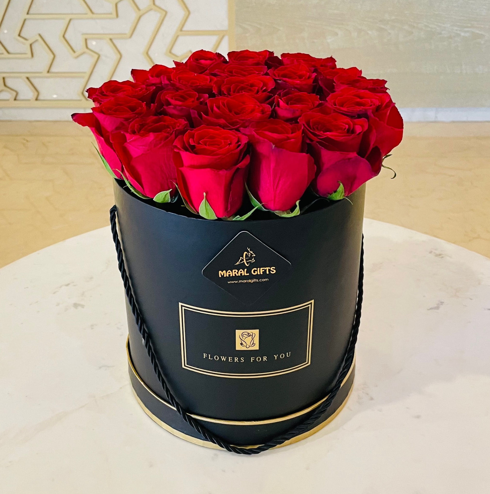 Red flower roses in a black box