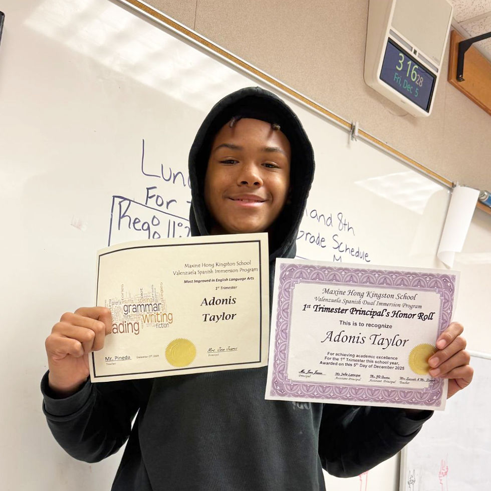 Adonis Taylor, 7th grade, proudly shows off his awards from the first trimester.