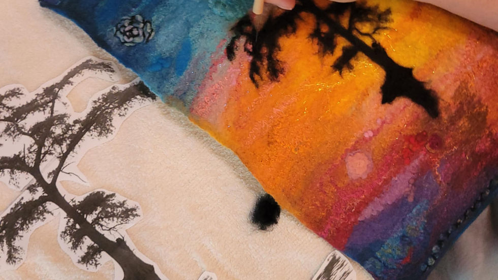 Needle felting the tree onto the wet felted background.