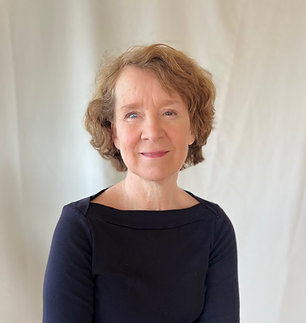 Smiling woman with short curly brown hair wearing a dark blue top, Chef Weeze Nelligan