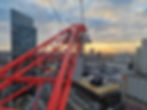 Statutory inspection view from a tower crane overlooking London skyline at sunset, showing lift equipment, construction sites