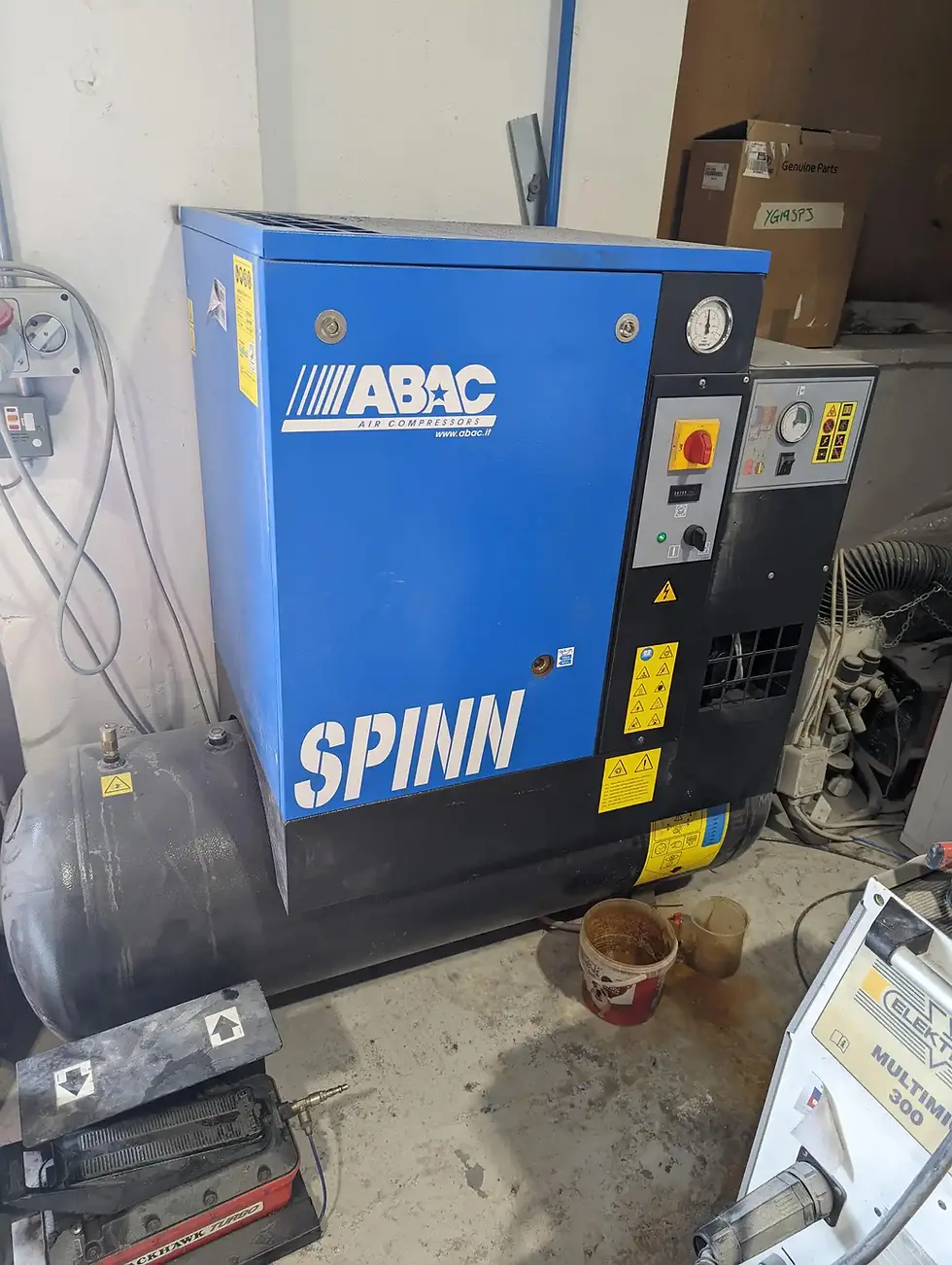 a blue compressor unit in an industrial setting